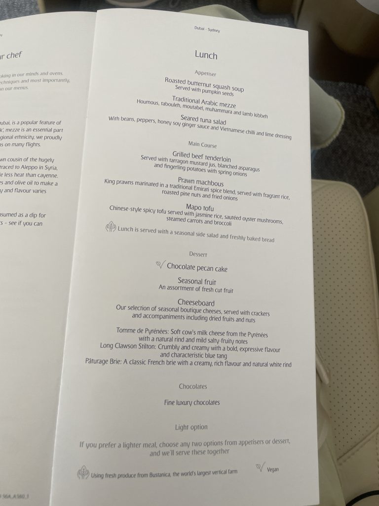 Emirates business class lunch menu for the Dubai to Sydney route, showing appetisers, main courses, and light meal options